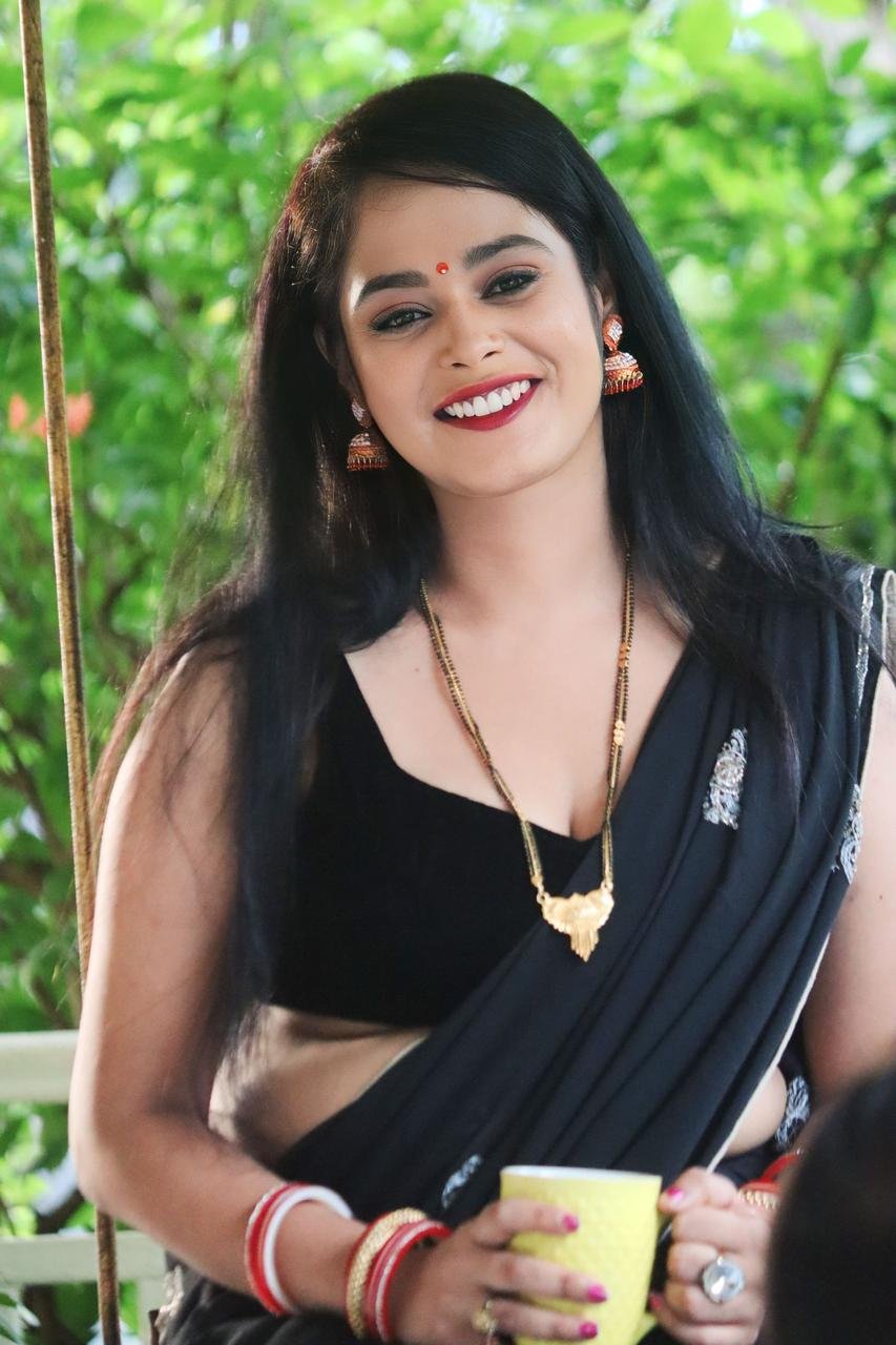 Ritu Rai smiling in black saree